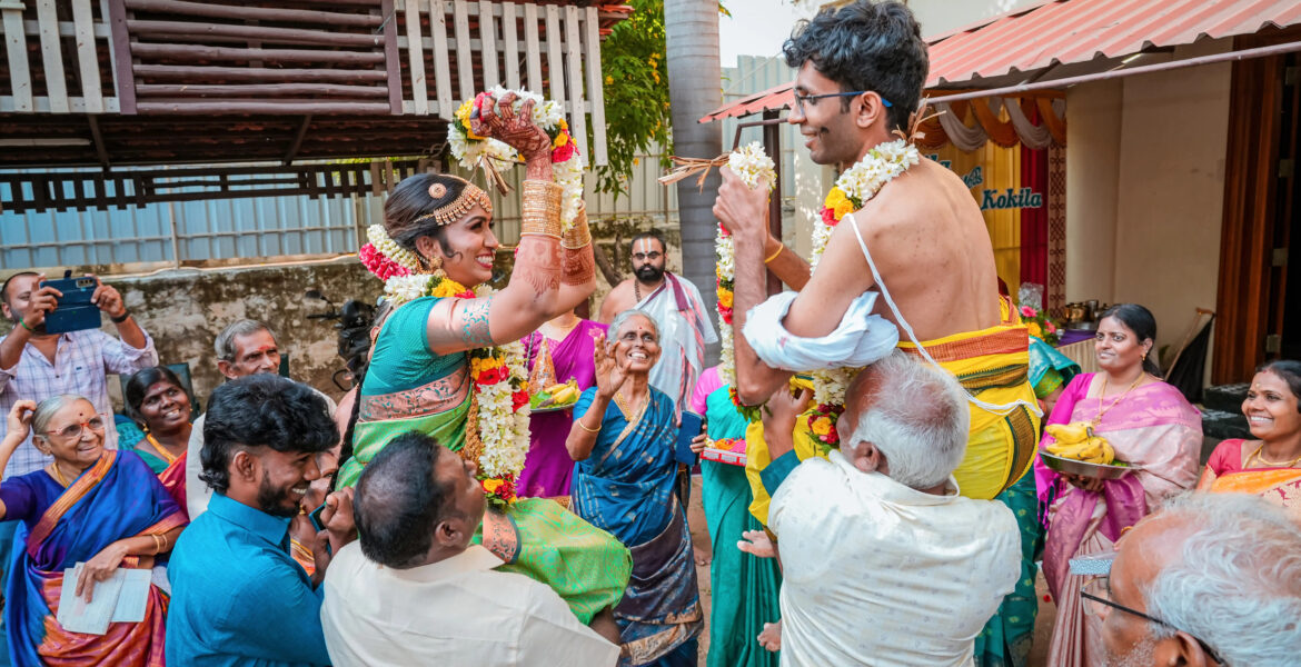 Ultimate Guide to Choosing the Perfect Wedding Photographer captures the garland exchange during Kapila & Kokila's Brahmin wedding photoshoot